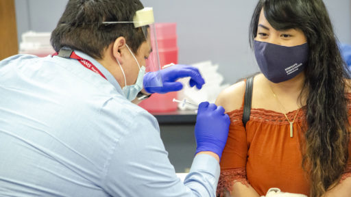 Marshallese woman receiving vaccine