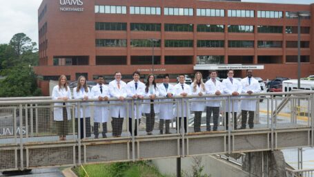 Group photo of the IM Mercy Class of 2029 in front of UAMS Northwest building.