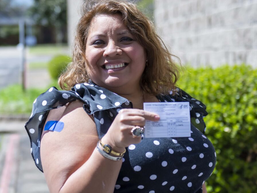 Irma Chavez showing vaccine card