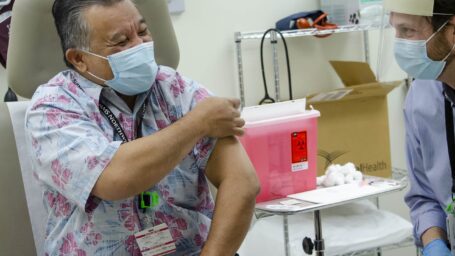 Dr. Riklon receiving COVID vaccine