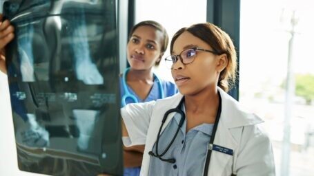 Two health care professionals looking at an xray.